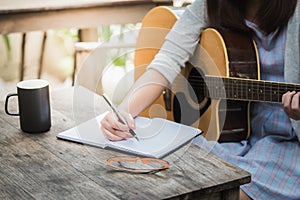 Women compose song and play guitar