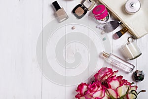 Women cosmetics and fashion items on white wooden background with copy space