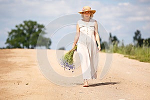 Women on country road with flowers