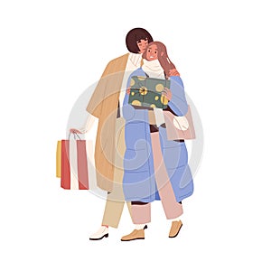 Women couple walking with presents and shopping bags. Girlfriends carrying gift boxes for winter holiday. Happy female