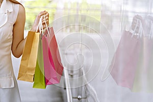 Women crazy shopaholic holding shopping bags , money ,credit card person at shopping malls.Fashionable Woman love online website