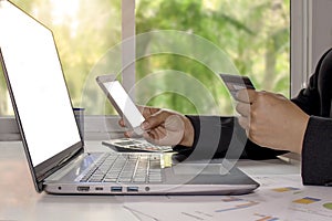 Women with credit cards and mobile phones, including laptops for working on desks, e-commerce concepts.