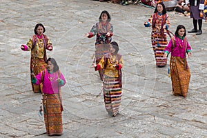 Female dancers at Tshechu religious festival in Paro fortress, Bhutan