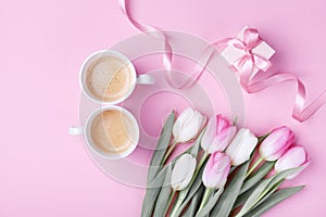 Women day 8 March concept. Morning coffee, gift box and spring tulip flowers on pink pastel background. Flat lay