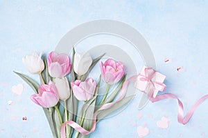 Women Day, Mother day background with gift box and beautiful spring tulip flowers on pastel blue table. Flat lay
