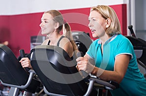 Women of different age training on exercycle