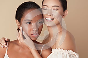 Women. Diversity Models Beauty Portrait. Two Ethnic Female With Nude Makeup And Smooth Hydrated Skin. photo