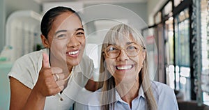 Women, doctor and patient with thumbs up on portrait for glasses, prescriptions and happy with choice. Optometrist photo