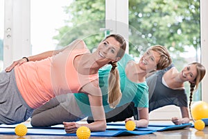 Women doing exercises for pelvis floor in postnatal regression c photo