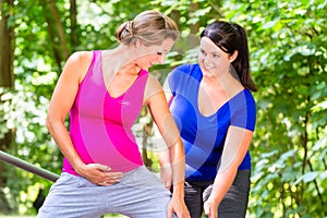 Women doing pregnancy fitness exercises together