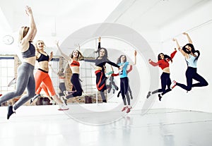 Women doing sport in gym, jumping, healthcare lifestyle people concept, modern loft studio