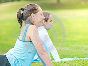 Women doing yoga in park