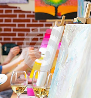 Women drawing on canvases during masterclass in the art studio, hands only