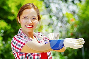 Women dressed with colorfull clothes putting on work gloves