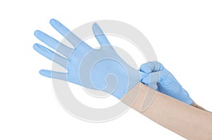 Women is dressing her hands in gloves. Isolated on white background.