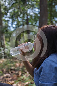 Women drink water in beautiful natural forests.