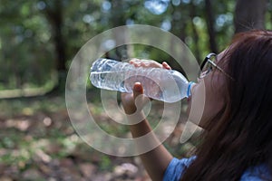 Women drink water in beautiful natural forests.