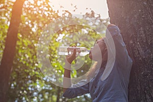 Women drink water in beautiful natural forests.