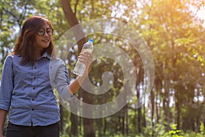 Women drink water in beautiful natural forests.