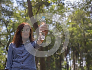 Women drink water in beautiful natural forests.