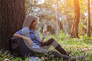 Women drink water in beautiful natural forests.