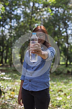 Women drink water in beautiful natural forests.