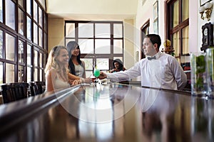 Women drinking cocktail in pub