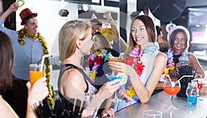 Women drinking cocktails in nightclub