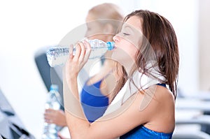 Women drinking water after sports