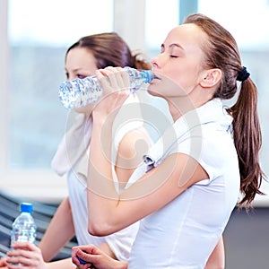 Women drinking water after sports