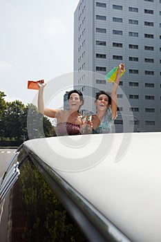 Women drinking wine in limousine