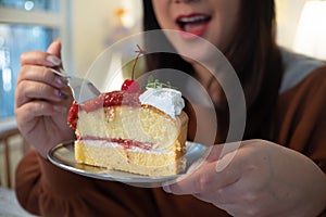 Women eating cake at home with happy face expression