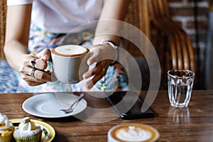 Women eating cupcakes coffee in breakfast food