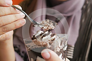 women eating Mousse cake close up