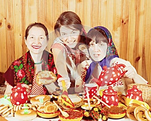 Women eating pancake with caviare during Shrovetide