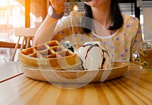 Women are eating waffles ice cream.