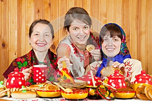 Women eats pancake with caviare photo