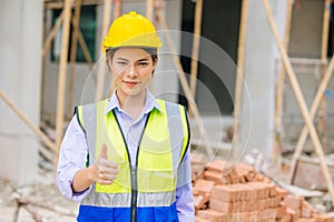 Women engineer worker foreman builder work in construction site portrait happy thumbs up for like and confirm pose