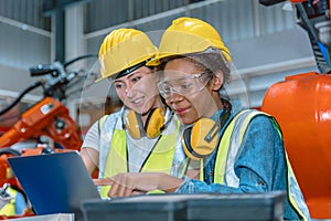 Women engineer worker working team helping together at work in modern advance machine factory