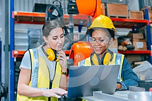 Women engineer worker working team training together at work in modern advanced robot welding machine factory