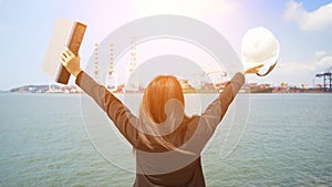 The women engineer working with container Cargo freight ship in shipyard