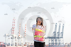 The women engineer working with container Cargo freight ship in shipyard at dusk for Logistic Import Export background, map earth