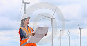 Women engineer working on site at wind turbine farm