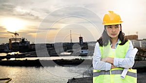 Women Engineering wearing hard hat and working at construction site