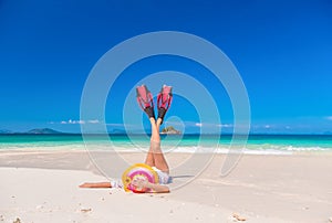 The women enjoy the sea by laying down on sand