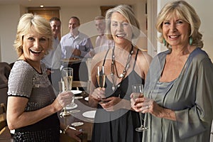 Women Enjoying Champagne At A Dinner Party