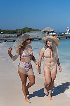 Women enjoying summer vacations on beach