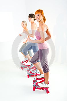 Women exercising on stepping machine