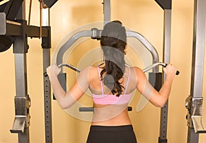 Women exercising on weightlifting machine