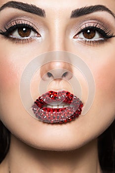 Women face with Swarovski crystals on lips